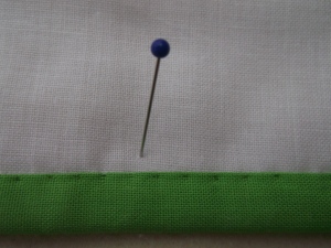 To give you some idea of how many (and how tiny my hand stitches are) I placed a little pin for scale!