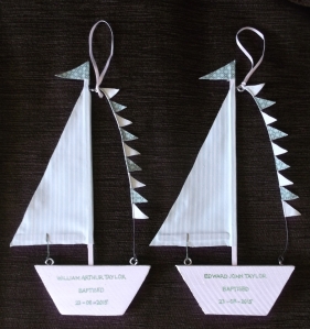 The first part of a handmade gift for my great nephew twins, some simple little decorations to hang in their bedroom - boy!!! were those little bunting flags fiddly to attach to the wire! The completed boats are only 3'' wide by 9'' high, so you can imagine how small the triangular flags are. I found some florist wire and a small mixed pack of balsa wood pieces, which have been residing FOREVER in my supply cupboard, so, a Stanley knife and some imagination, plus a couple of holes here and there, a few picture hooks, combined with some leftover fabric to match their cot quilts (I made earlier in the year) resulted in two little boat baptism gifts. I have two patchwork cushion covers also on the go to commemorate their precious day too - more on those soon! 